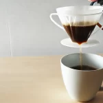 A realistic photograph style image of drip bag coffee also known as hanging ear coffee in a 16 9 aspect ratio The scene should focus on a single drwebp